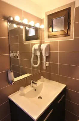 a bathroom with a sink and a mirror at Le monte rosso in Porto Ota