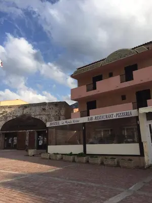 a large building with a sign in front of it at Le monte rosso in Porto Ota