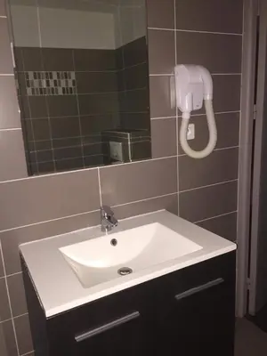a bathroom with a white sink and a mirror at Le monte rosso in Porto Ota