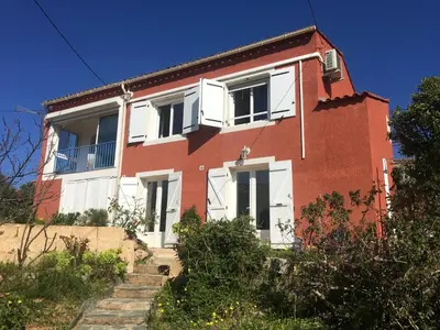 a red brick house with white doors and windows at Corse Villa Porticcio vue Mer in Porticcio