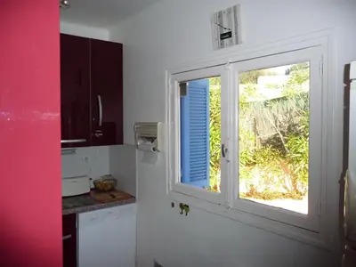a kitchen with a window and a counter at Corse Villa Porticcio vue Mer in Porticcio