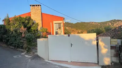 a house with a white gate in front of a house at Corse Villa Porticcio vue Mer in Porticcio