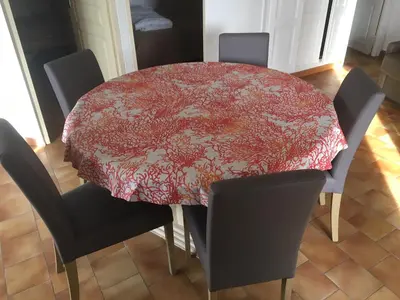 a dining room table with chairs and a red table cloth at Vue mer panoramique plage 50m Porticcio Corse in Porticcio