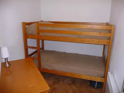 a bunk bed in a room with a table at Vue mer panoramique plage 50m Porticcio Corse in Porticcio