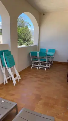 a room with chairs and a table and a window at Vue mer panoramique plage 50m Porticcio Corse in Porticcio