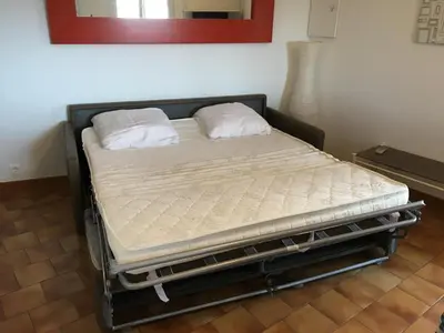 a bed with two pillows on it in a room at Vue mer panoramique plage 50m Porticcio Corse in Porticcio