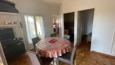 a room with a table and chairs with a red box on it at Vue mer panoramique plage 50m Porticcio Corse in Porticcio