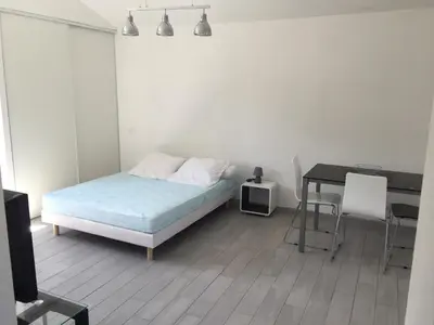 a bedroom with a bed and a desk and a table at A Casetta di Rosa in Corte