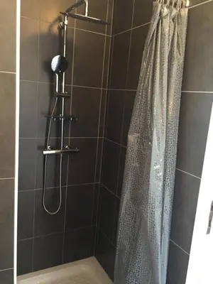 a shower with a shower curtain in a bathroom at A Casetta di Rosa in Corte