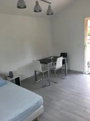 a room with a table and chairs and a bed at A Casetta di Rosa in Corte