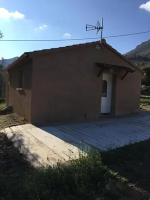 a small brown building with a white door at A Casetta di Rosa in Corte