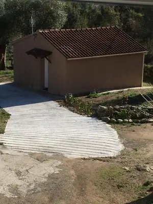 a building with a concrete walkway in front of it at A Casetta di Rosa in Corte