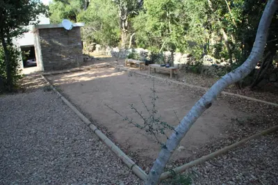 a fire hydrant in a yard with a bench at Résidence Terre et Mer in Sainte-Lucie de Porto-Vecchio