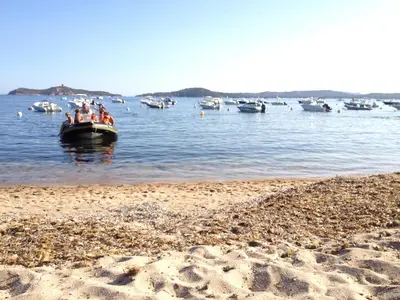 a group of people in a boat in the water at Résidence Terre et Mer in Sainte-Lucie de Porto-Vecchio