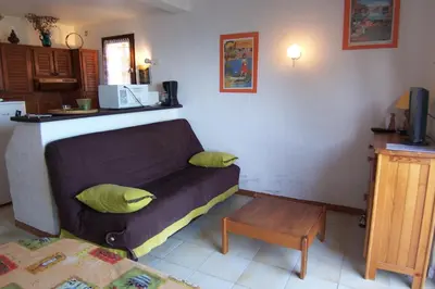 a living room with a couch and a table at Asphodele in Tarcu