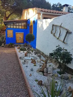 a blue and white house with a garden in front of it at Terra Rossa- clim- pieds dans l'eau in Conca