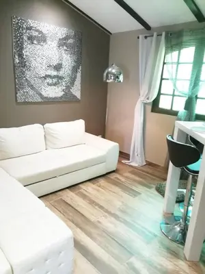 a living room with a white couch and a table at Terra Rossa- clim- pieds dans l'eau in Conca