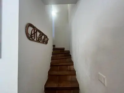a stairway with a wooden rail and a stair case at CEDRAT in Porto-Vecchio