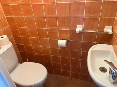 a bathroom with a toilet and a sink at CEDRAT in Porto-Vecchio