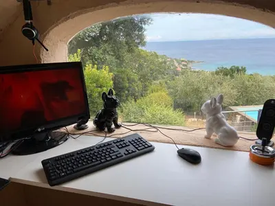 a desk with a computer monitor and a keyboard and mouse at Domise in Conca