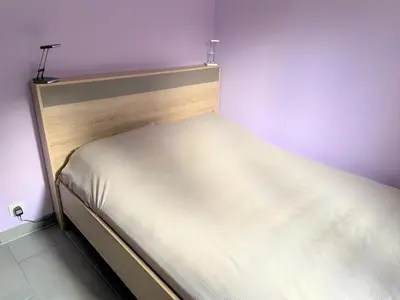 a white bed in a room with purple walls at Domise in Conca