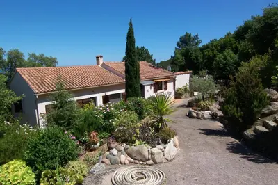 a house with a garden with rocks and plants at Domise in Conca