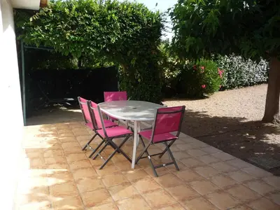 a walkway next to a white building with bushes at Carestella in Porto-Vecchio