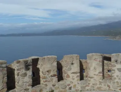 a stone wall with a large body of water at A Luna Rossa in Coti-Chiavari