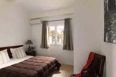 a bedroom with a bed and a window at Résidence Marina Rossa in Porto-Vecchio