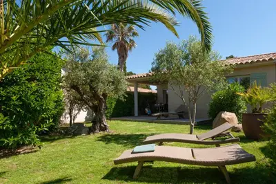 two lounge chairs in the yard of a house at Résidence Marina Rossa in Porto-Vecchio