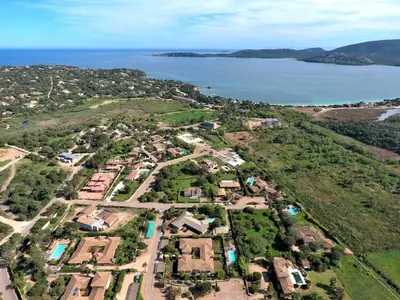 an aerial view of a village with the ocean at Résidence Marina Rossa in Porto-Vecchio