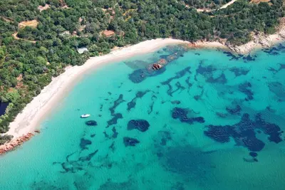 an aerial view of a beach with rocks and water at Résidence Marina Rossa in Porto-Vecchio