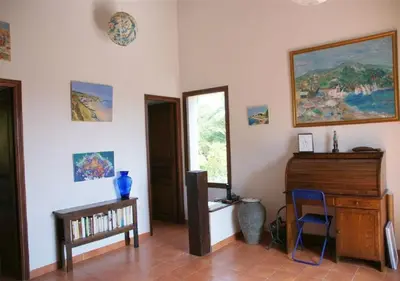 a living room with a piano and a window at Maja in Favone