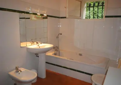a bathroom with a sink and a toilet and a tub at Maja in Favone
