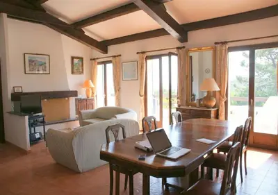 a living room with a table with a laptop on it at Maja in Favone