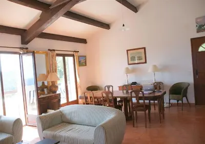 a living room with a table and chairs at Maja in Favone