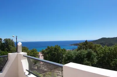 a view of the ocean from the balcony of a house at Maja in Favone