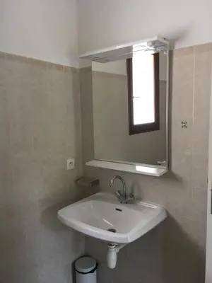 a bathroom with a white sink and a mirror at Domaine Valdaronu in Sainte-Lucie de Porto-Vecchio