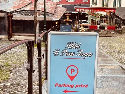 a sign that reads half a run tavern and a parking pump at Hôtel U Passa Tempu in Corte