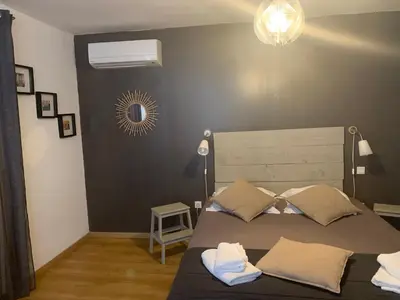 a bedroom with a bed with two towels on it at Hôtel U Passa Tempu in Corte