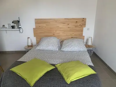 a bedroom with a bed with two yellow pillows at Hôtel U Passa Tempu in Corte