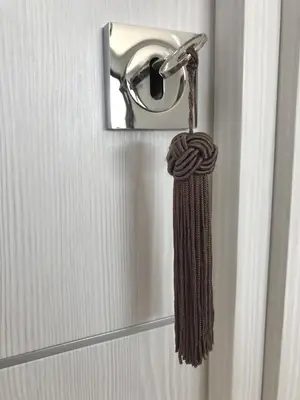 a towel hanging from a door knob with a rope at Sweet Holiday in Porto-Vecchio