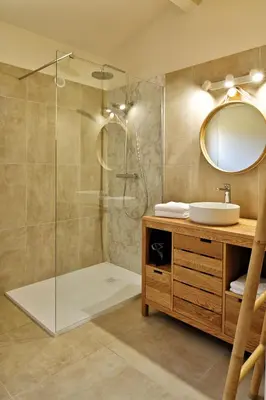 a bathroom with a shower with a sink and a mirror at Villas Abbartello in Olmeto