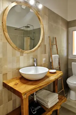 a bathroom with a sink and a mirror and a toilet at Villas Abbartello in Olmeto