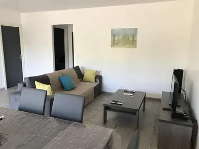 a living room with a couch and a table at Mini-villas Célia à BONIFACIO in Bonifacio
