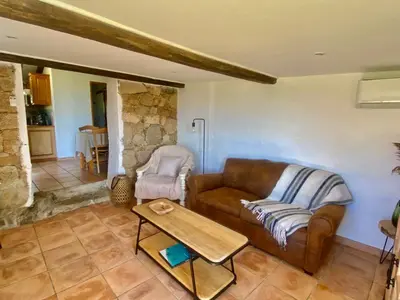 a living room with a couch and a table at BERGERIE PARADISU, Domaine de l Ogliastru in Olmeto