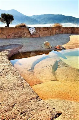 a puddle of water on the ground in a desert at BERGERIE PARADISU, Domaine de l Ogliastru in Olmeto