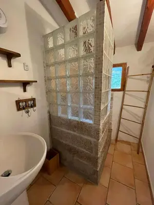 a bathroom with a shower with a tub and a sink at BERGERIE PARADISU, Domaine de l Ogliastru in Olmeto
