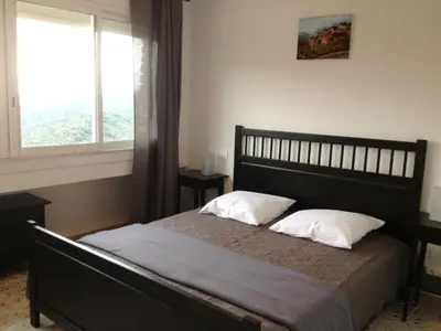 a bedroom with a bed with two pillows and a window at Casa Suprana in Partinello