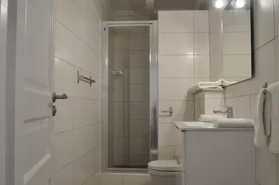 a bathroom with a shower and a toilet and a sink at Résidence Casa Cintrone in Porto Pollo